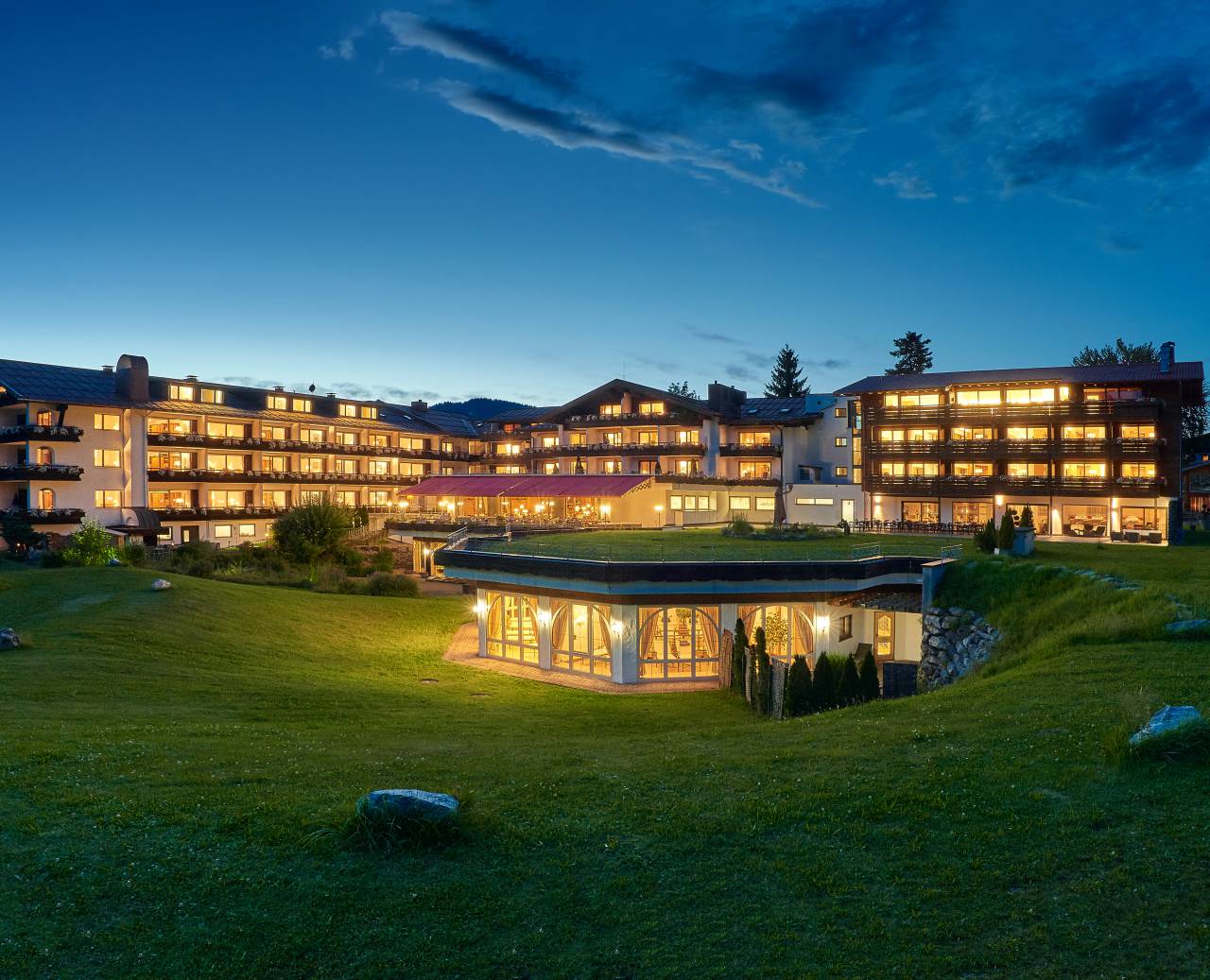 Hotel in Oberstdorf SCHÜLE'S Gesundheitsresort & Spa bei Abenddämmerung